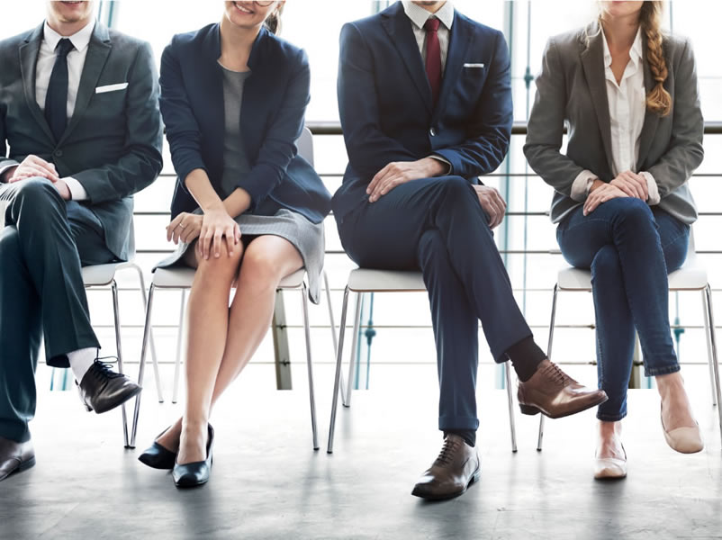 professional people seated in chairs waiting for interview